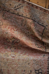 Distressed texture of a Vintage Oushak rug, showing visible foundation in dusty blush, sand.