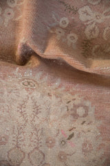 Distressed Oushak runner pile, dusty rose floral motifs with faint foundation showing.