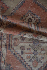 Distressed Oushak runner pile in terracotta, beige, and dark aubergine geometric patterns.