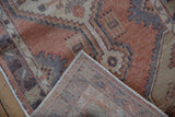 Vintage distressed Oushak runner corner, revealing its worn pile and hand-knotted foundation.