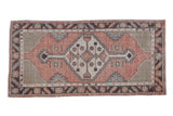 Distressed Oushak runner corner, terracotta field, geometric aubergine and ivory border.