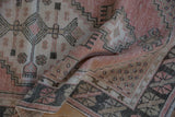 Folded Oushak runner revealing low, even wear and a soft, distressed texture.