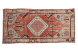 Distressed vintage Oushak runner, faded brick red field, ivory hexagonal medallion, tulip motifs.