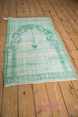 Distressed texture and variegated mint green, aqua blue hues of a vintage Oushak rug.