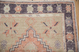 Vintage Distressed Oushak runner detail: stepped medallion, pinwheel motifs, aubergine, melon, and worn pile.