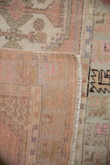 Textured, distressed pile and hand-knotted reverse of the vintage Oushak rug runner.