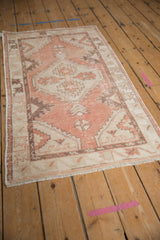 Decorative wear and abrash texture of vintage Oushak rug in blush, ivory, coffee brown tones.