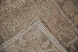 Textured beige distressed Oushak runner pile showing foundation wear and sturdy side selvage.