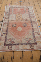 Distressed Vintage Oushak rug, prayer design motif with cantaloupe, ivory, and aubergine tones.