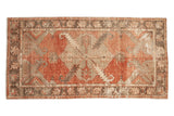 Distressed vintage Oushak rug runner, diamond floral medallion, madder red, brown, and ivory.