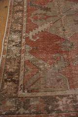 Worn madder root red and chocolate brown distressed Oushak runner pile with visible foundation.