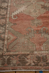 Distressed Oushak runner showing madder red, chocolate brown motifs, foundation wear, and light fringe.