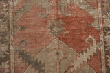 Worn pile texture of vintage Oushak runner with distressed madder red and dusty brown floral motifs.