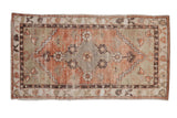 Vintage distressed Oushak runner with worn terracotta, sage green floral medallion, 2'8