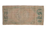 Distressed vintage Oushak rug runner in beige with hexagonal medallion and emerald green motifs.