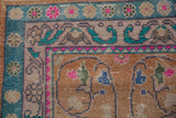 Distressed vintage Oushak rug corner, faded rust field with vinery and vibrant floral borders.