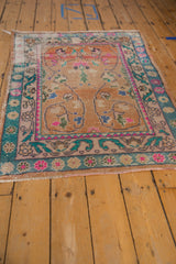 Vintage distressed Oushak rug, faded rust field with hot pink and turquoise vinery, visible pile wear.