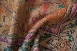 Distressed Oushak rug pile with visible foundation, showing faded rust, hot pink, turquoise.