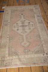Distressed Oushak runner mid-section with geometric motifs in dusty apricot and pale seafoam.