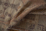 Distressed Oushak rug runner pile with muted apricot and aubergine tones.