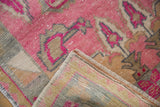 Visible foundation and intact selvage on the worn hot pink vintage Oushak rug.
