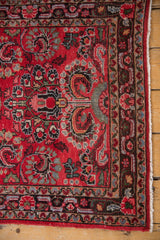 Vintage Dargezine rug runner detail: cherry red millefleur vinery, dusty blue accents, low pile, intact selvage.