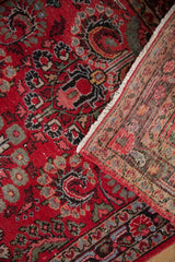 Vintage Dargezine runner close-up, showcasing cherry red millefleur pattern and hand-knotted foundation.