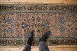 Distressed vintage Lilihan rug with floral field and geometric border in dusty mauve and blue.