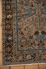 Distressed Lilihan runner corner shows blue geometric border and muted floral field.