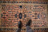 Dusty rose field of a vintage Lilihan rug with navy floral bouquet and tree-of-life patterns.