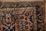 Vintage distressed Lilihan rug corner detail, dusty rose field, navy floral vines, meandering border.