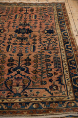 Distressed Lilihan rug with dusty rose field and navy, sky blue tree-of-life motifs.