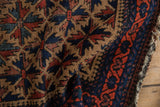Close-up of hand-knotted vintage Belouch rug with lattice starburst and pawn border.