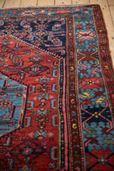 Vintage Borchalou rug's intricate Herati floral design, geometric border in cherry red, sky blue.