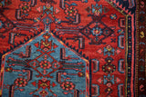 Vintage Borchalou rug detail: cherry red field's Herati design meeting aqua blue floral medallion.