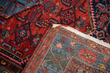 Persian Borchalou rug's hand-knotted back revealing detailed red, blue, and pink geometric floral pile.