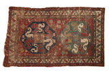 Antique Caucasian rug, cherry red field, navy, green cloudband medallions, worn pile, 4'3