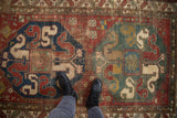 Antique Caucasian rug showing cloudband medallions, geometric patterns, and foundation wear.