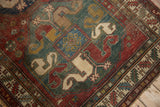 Collector antique Caucasian rug: worn pile reveals foundation, geometric red, green, beige patterns.