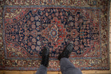 Navy blue vintage Northwest Persian rug with faded blush floral field and asymmetric medallion.