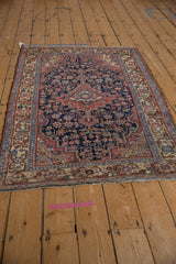 Fringe and worn antique ivory border with faded blush motifs on vintage Persian rug.