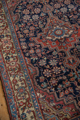 Navy field and ivory border of a vintage Northwest Persian rug with floral blossoms.