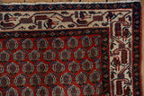 Intricate ivory and navy borders frame the brick-red staggered field of a vintage Persian Serbend rug.