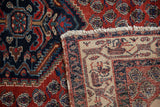 Folded corner of a vintage Persian rug revealing its hand-knotted foundation and wool pile.