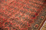 Distressed Borchalou carpet: raspberry field with serrated floral motifs and contrasting geometric border.