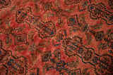 Distressed vintage Borchalou rug showing even wear, raspberry red, and brown floral cartouches.