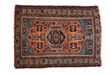 Vintage Borchalou rug mat, rust field with sky blue and navy geometric medallion.