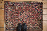 Vintage Dargezine rug corner, hand-knotted dusty burgundy Herati field and meandering leaf border.