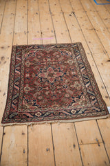 Dargezine rug corner with dusty burgundy meandering leaf border and Herati field.