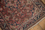 Vintage Dargezine rug corner: dusty burgundy, navy border, Herati field pattern, and intact selvage.